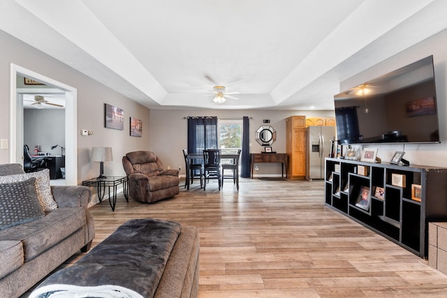 11851 Sanders Rd, Richwood, OH 43344 - living area with a raised ceiling, ceiling fan, and light wood-style flooring