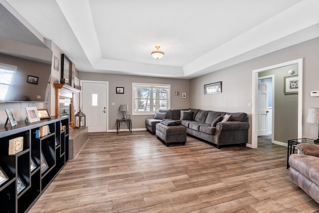 11851 Sanders Rd, Richwood, OH 43344 - living area featuring baseboards, light wood finished floors, and a raised ceiling