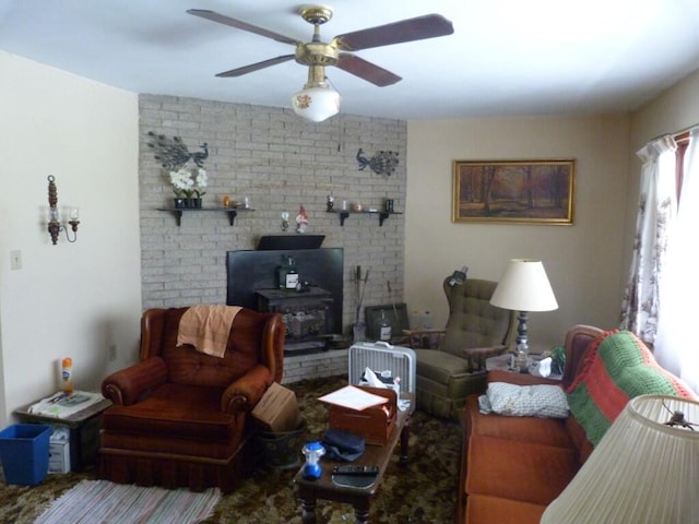 727 County Road 50, Ada, OH 45810 - living room with a wood stove, ceiling fan, and brick wall