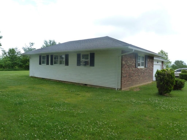 727 County Road 50, Ada, OH 45810 - view of side of property with brick siding, a lawn, and a garage