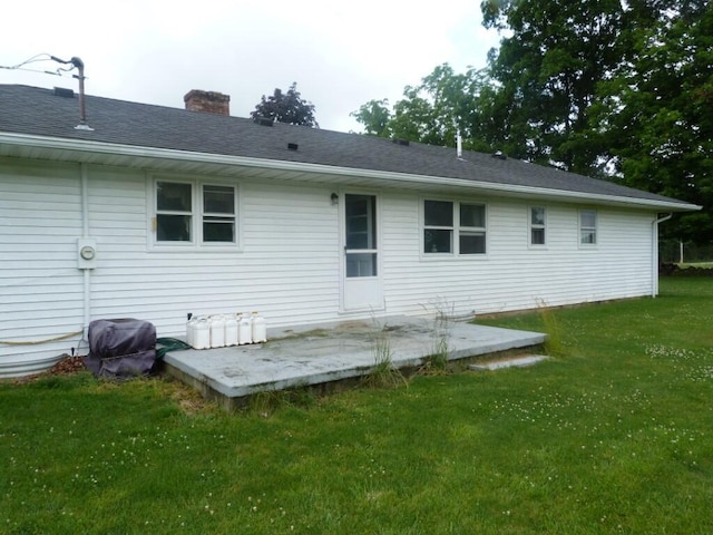 727 County Road 50, Ada, OH 45810 - rear view of property with a lawn and a chimney