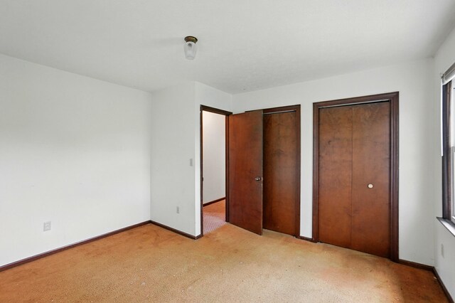 1985 Fox Run, Troy, OH 45373 - unfurnished bedroom with multiple closets and carpet floors