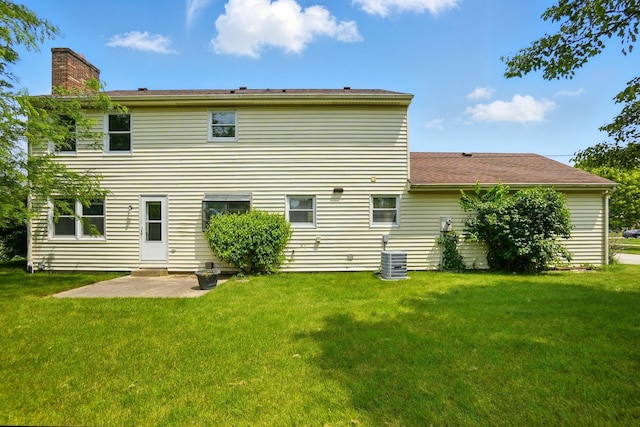 1985 Fox Run, Troy, OH 45373 - rear view of property featuring a chimney, a lawn, and a patio