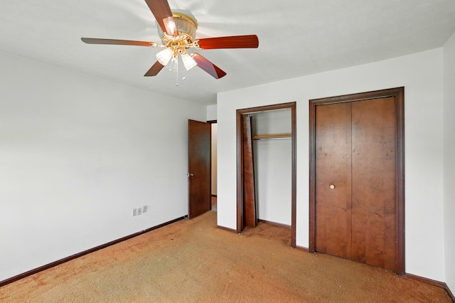 1985 Fox Run, Troy, OH 45373 - unfurnished bedroom featuring two closets, carpet floors, and ceiling fan