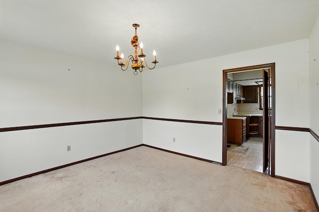 1985 Fox Run, Troy, OH 45373 - spare room featuring light colored carpet and a chandelier