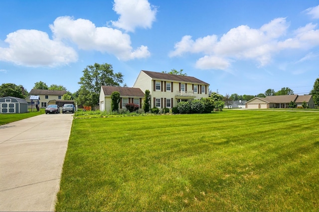 1985 Fox Run, Troy, OH 45373 - colonial-style house with a front lawn, driveway, and a storage unit