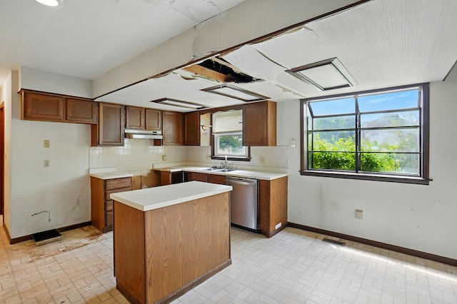 1985 Fox Run, Troy, OH 45373 - kitchen featuring stainless steel dishwasher, under cabinet range hood, brick patterned flooring, and a center island
