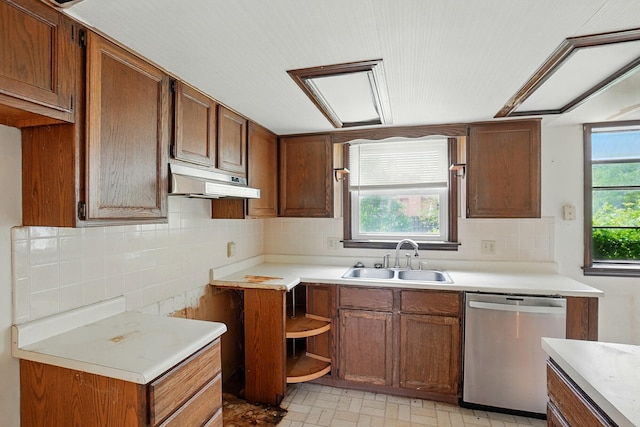 1985 Fox Run, Troy, OH 45373 - kitchen with stainless steel dishwasher, under cabinet range hood, light countertops, and brown cabinets