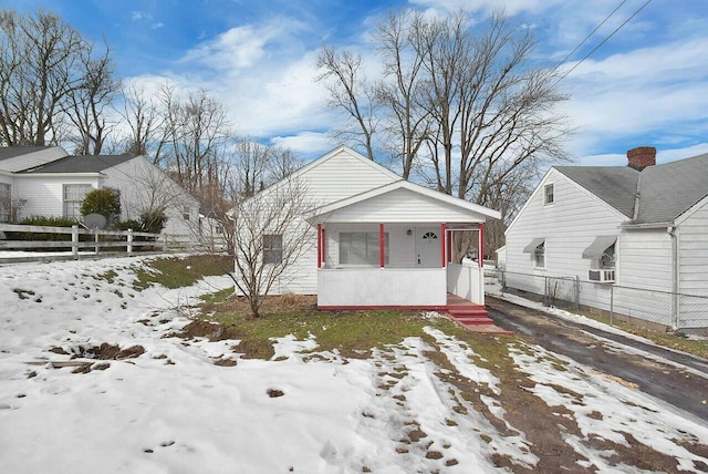 bungalow featuring a porch and cooling unit