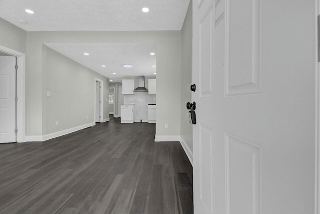 unfurnished living room with dark hardwood / wood-style floors