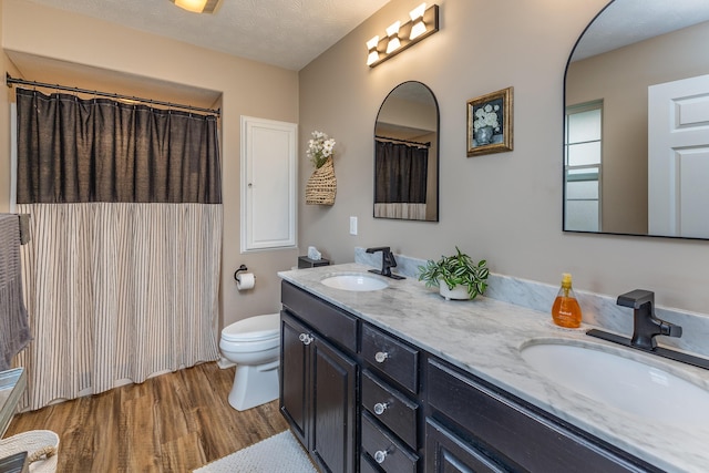 1280 Candlelite Ln, Fairborn, OH 45324 - bathroom with toilet, wood finished floors, double vanity, and a shower with shower curtain
