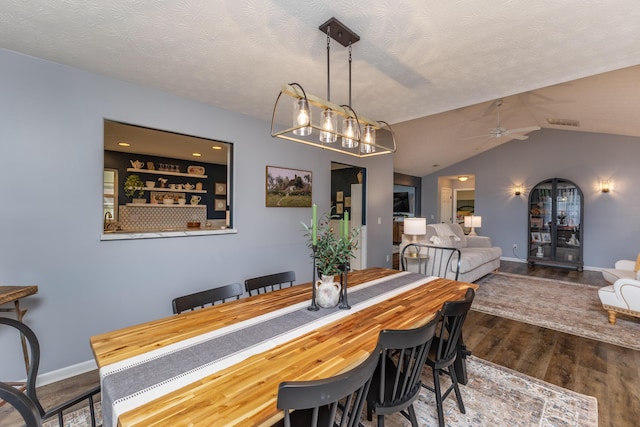 1280 Candlelite Ln, Fairborn, OH 45324 - dining space with wood finished floors, a ceiling fan, baseboards, vaulted ceiling, and a textured ceiling