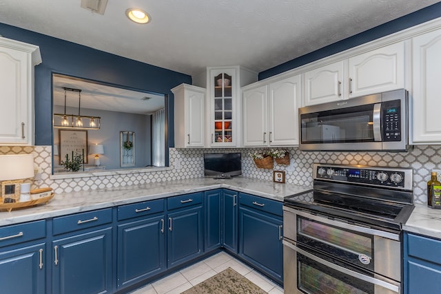 1280 Candlelite Ln, Fairborn, OH 45324 - kitchen featuring stainless steel appliances, blue cabinetry, white cabinets, tasteful backsplash, and light tile patterned floors