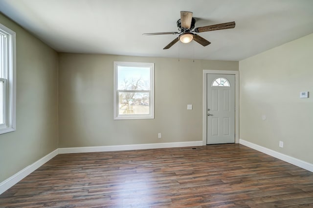 entryway with a healthy amount of sunlight, baseboards, a ceiling fan, and wood finished floors