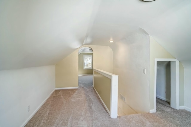 bonus room featuring visible vents, lofted ceiling, carpet, and baseboards