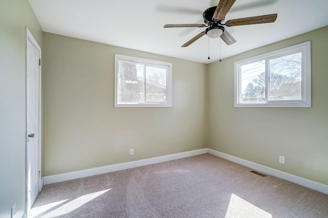 unfurnished bedroom featuring visible vents, baseboards, carpet, and ceiling fan