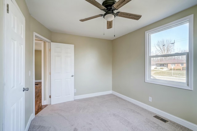 carpeted bedroom featuring visible vents, a ceiling fan, and baseboards