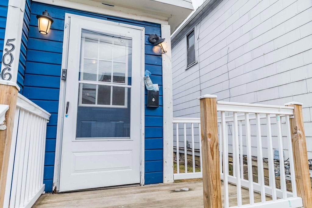 view of exterior entry featuring a deck