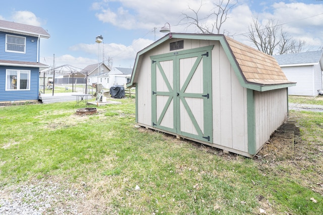 view of shed with an outdoor fire pit