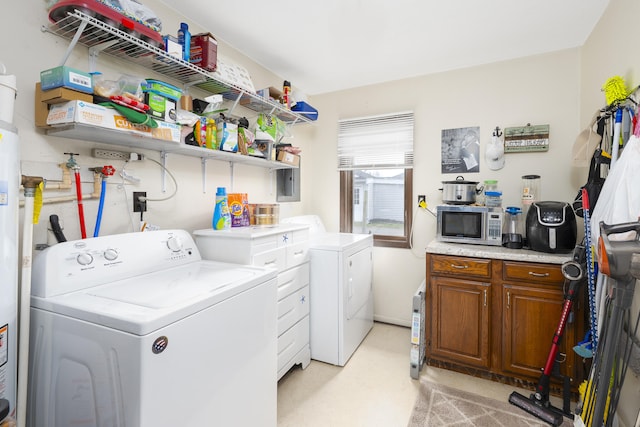 clothes washing area with washing machine and clothes dryer and laundry area