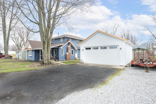 view of front facade featuring an outbuilding and a detached garage