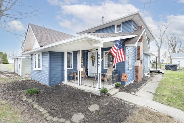 bungalow-style home with a porch and a shingled roof