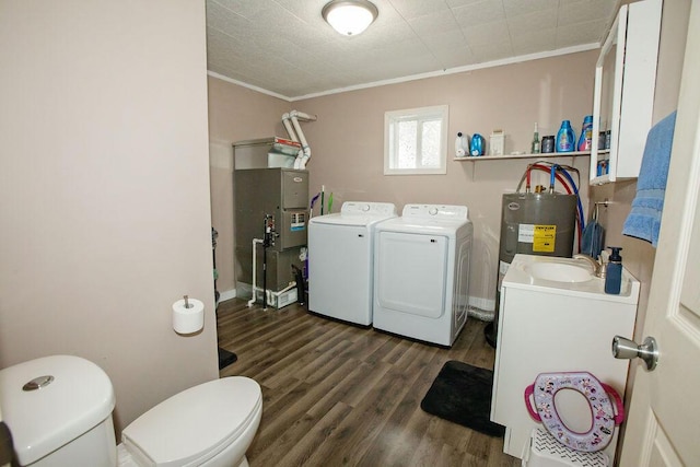 804 Robinson Ave, Kenton, OH 43326 - laundry room with washing machine and dryer, ornamental molding, dark wood-type flooring, and electric water heater