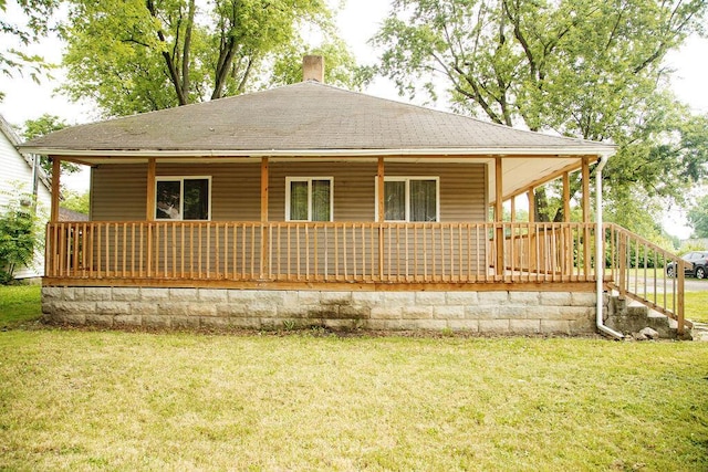 804 Robinson Ave, Kenton, OH 43326 - back of house with a yard, a chimney, a porch, and roof with shingles