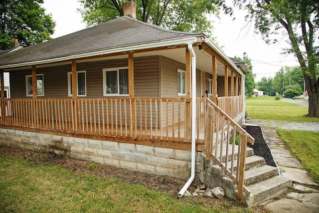 804 Robinson Ave, Kenton, OH 43326 - single story home featuring a chimney, covered porch, roof with shingles, and a front yard