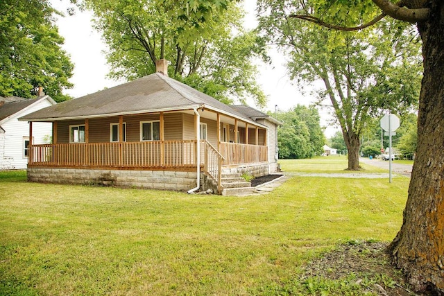 804 Robinson Ave, Kenton, OH 43326 - view of front of property featuring covered porch, a chimney, a front yard, and a shingled roof