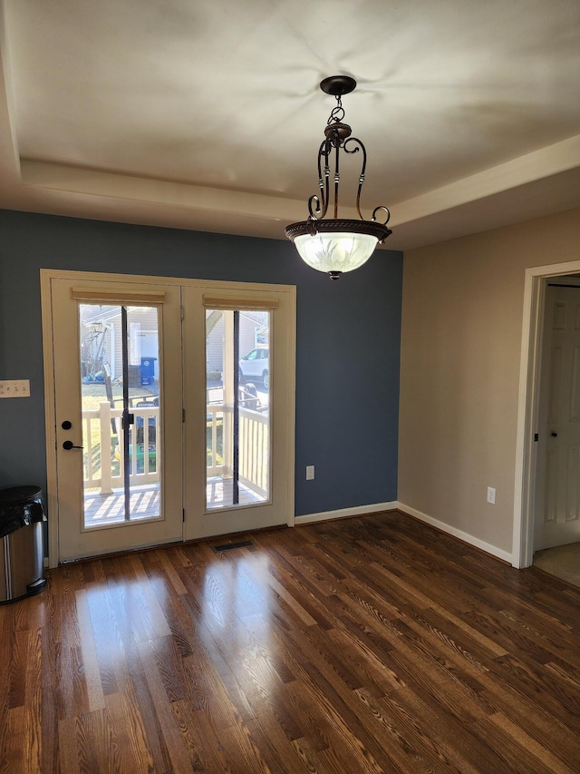 unfurnished room featuring visible vents, baseboards, and wood finished floors