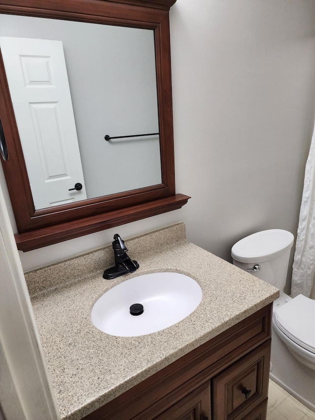 bathroom featuring vanity and toilet