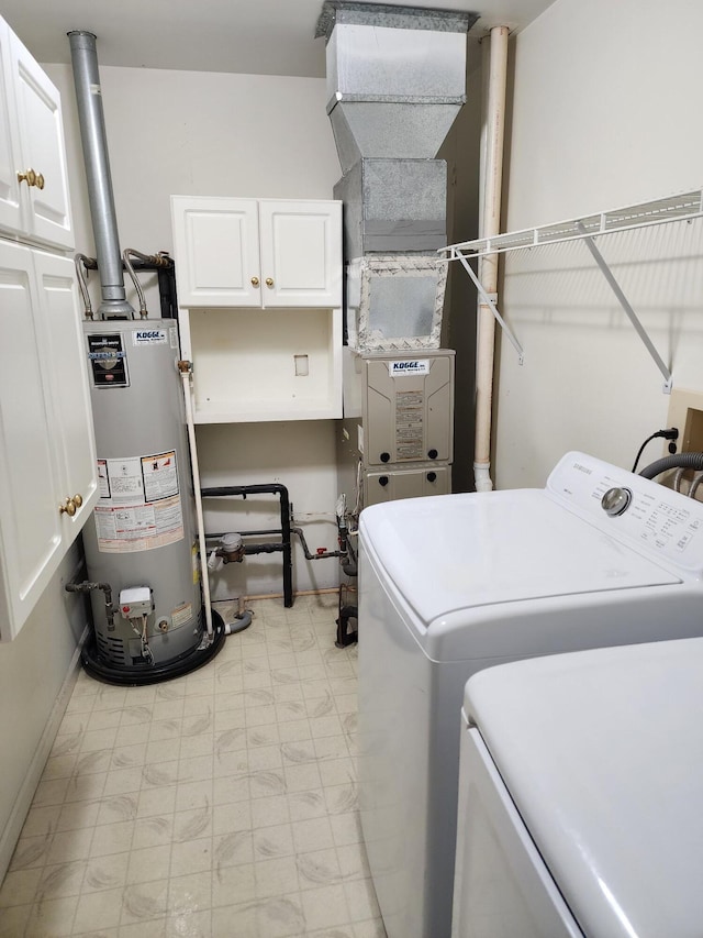 laundry area with water heater, cabinet space, light floors, and washing machine and clothes dryer