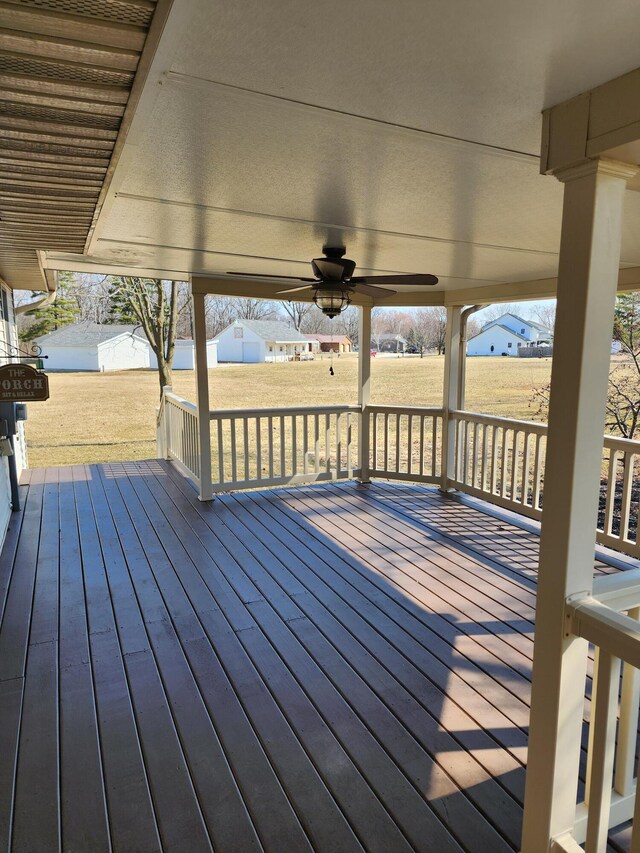 single story home featuring brick siding, a porch, a front yard, and a shingled roof