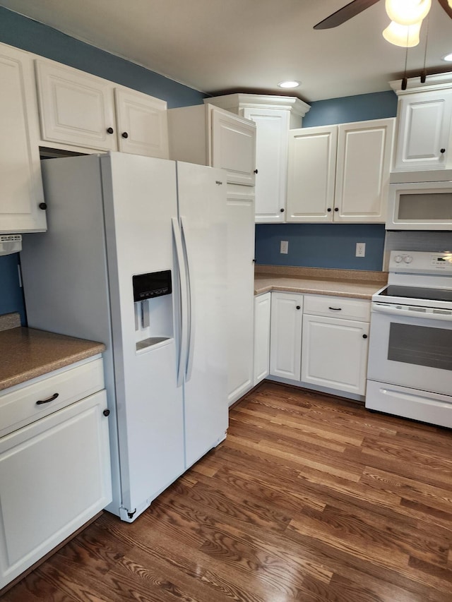 kitchen with white appliances, dark wood-style flooring, ceiling fan, light countertops, and white cabinetry