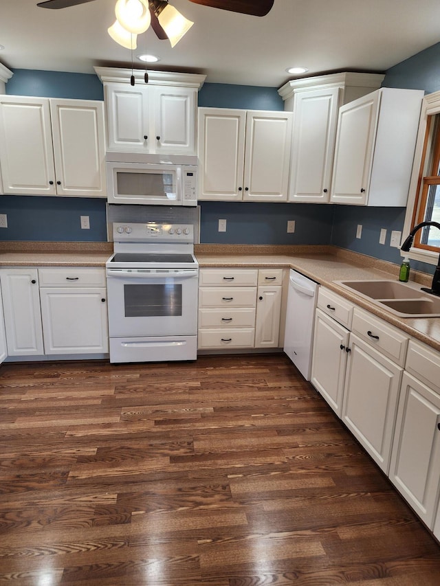 kitchen with a sink, dark wood-style floors, white appliances, and white cabinets