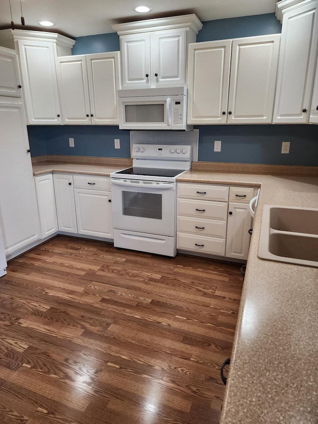 kitchen with recessed lighting, white appliances, white cabinetry, and dark wood-style flooring