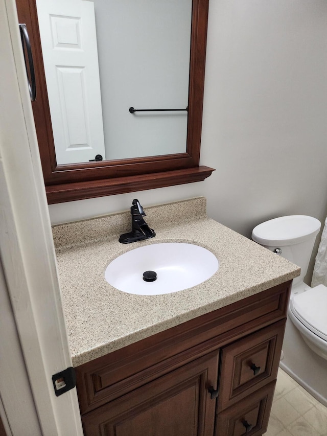 bathroom with toilet and vanity