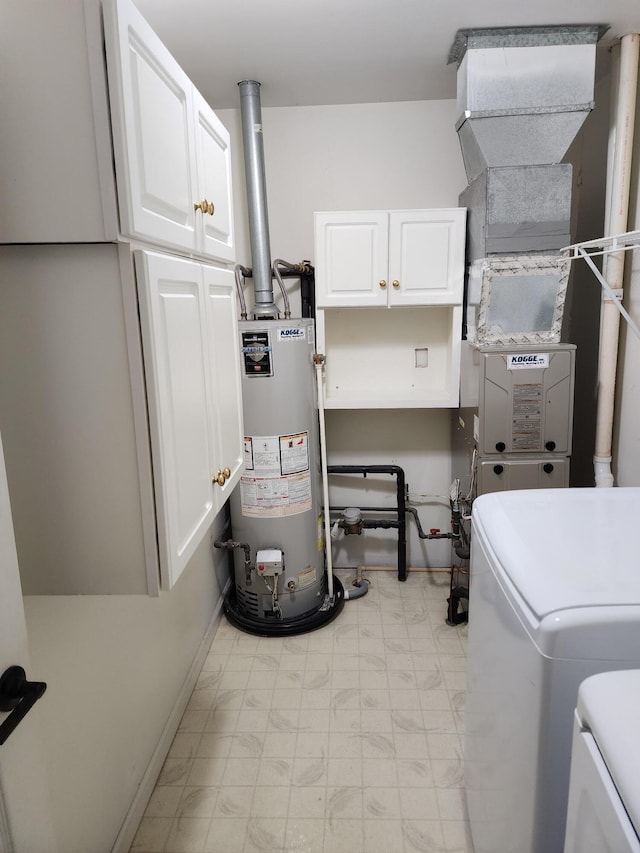 laundry area featuring gas water heater, cabinet space, separate washer and dryer, and light floors