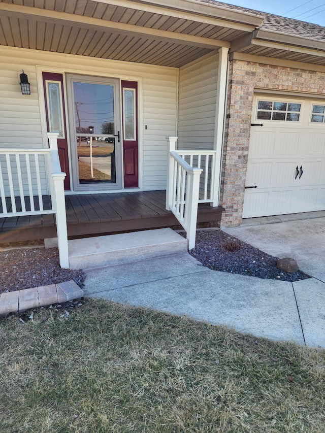 property entrance featuring a garage and a porch