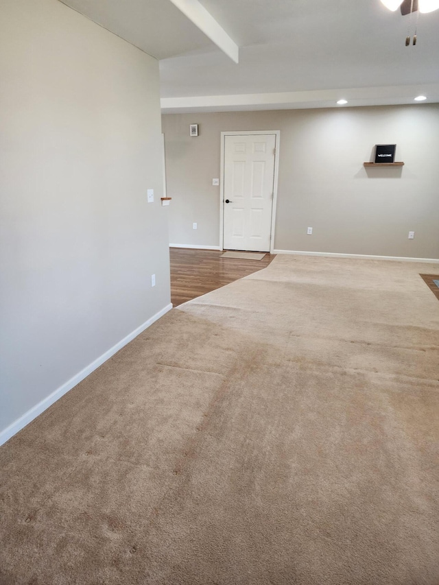 carpeted empty room featuring beamed ceiling, recessed lighting, and baseboards