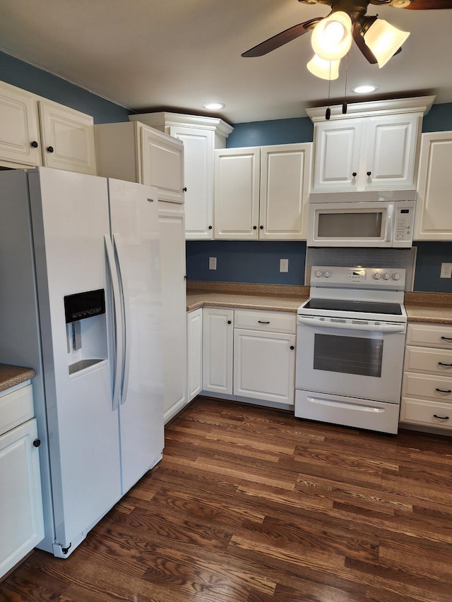 kitchen with white appliances, white cabinets, and dark wood-style flooring