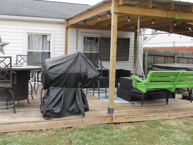 wooden deck featuring a hot tub