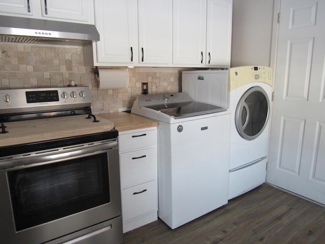 washroom featuring dark wood-type flooring and washer and clothes dryer