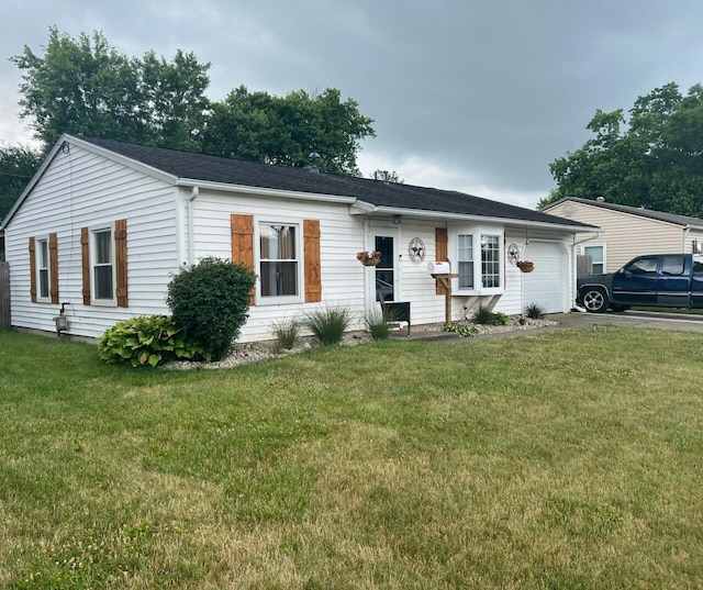 ranch-style home with a garage and a front yard