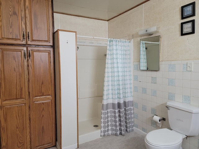 bathroom with walk in shower, tile patterned floors, toilet, and tile walls