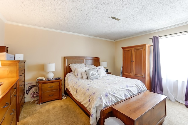 bedroom featuring ornamental molding, light carpet, a textured ceiling, and visible vents