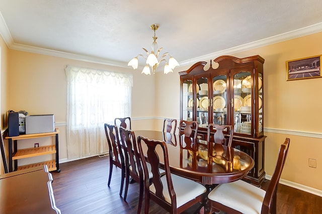 dining space featuring crown molding, baseboards, a notable chandelier, and wood finished floors