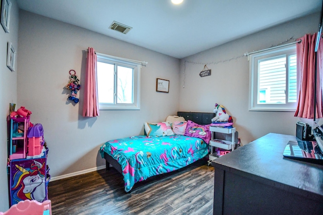 bedroom with dark wood-type flooring