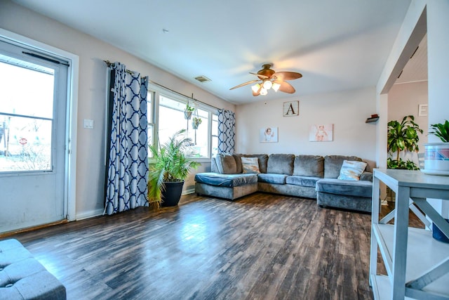 living room with dark wood-type flooring and ceiling fan